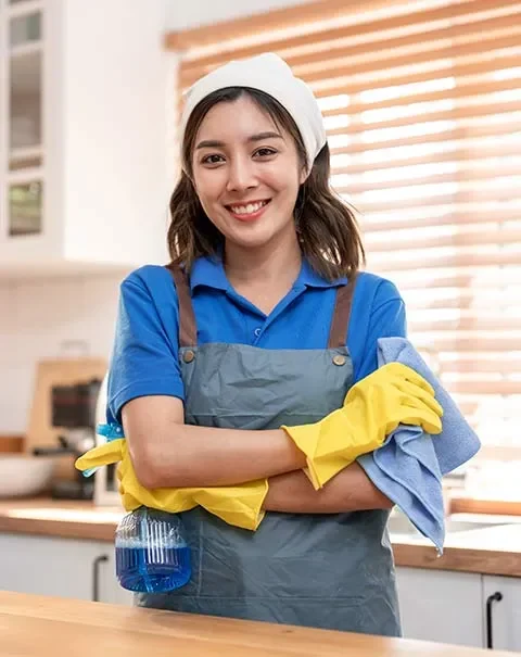 a woman wearing gloves and a cleaning agent